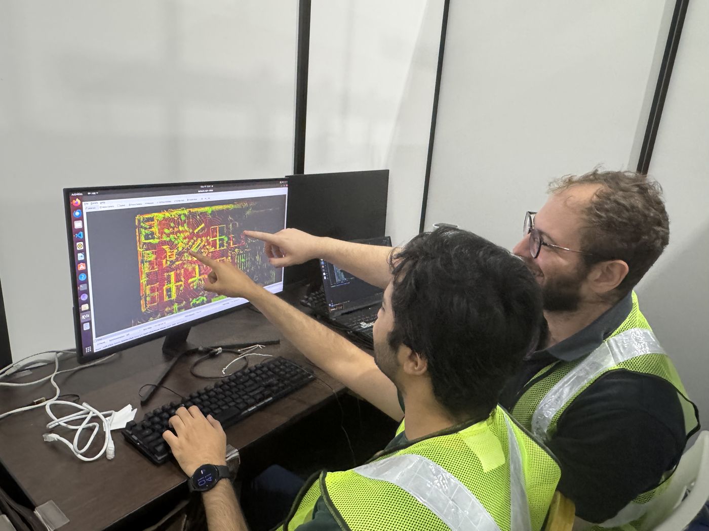 Curium engineers reviewing point-cloud data on site